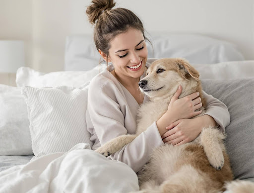 Woman hugging light brown dog